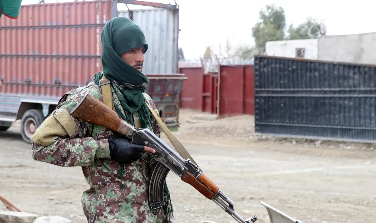 A Taliban soldier stands watch at the Afghanistan-Pakistan border in Spin Boldak, in the year 2022